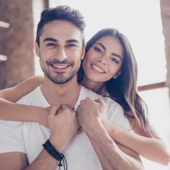 Hispanic couple hugging and smiling