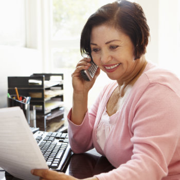 Senior Hispanic woman working as a receptionist