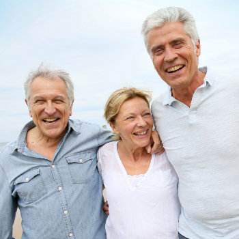 Senior people walking on the beach