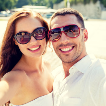 couple in love in sunglasses taking a selfie