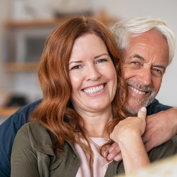 smiling middle aged couple, dental implants