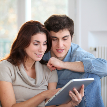 couple using electronic tablet