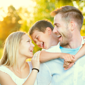 father, mother and little son having fun outdoors