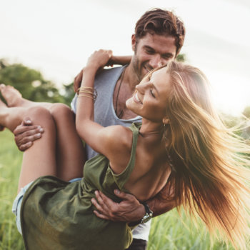 laughing Woman Being Carried By Her Boyfriend