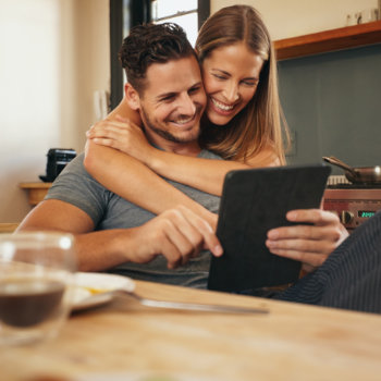 young couple in love are using a tablet