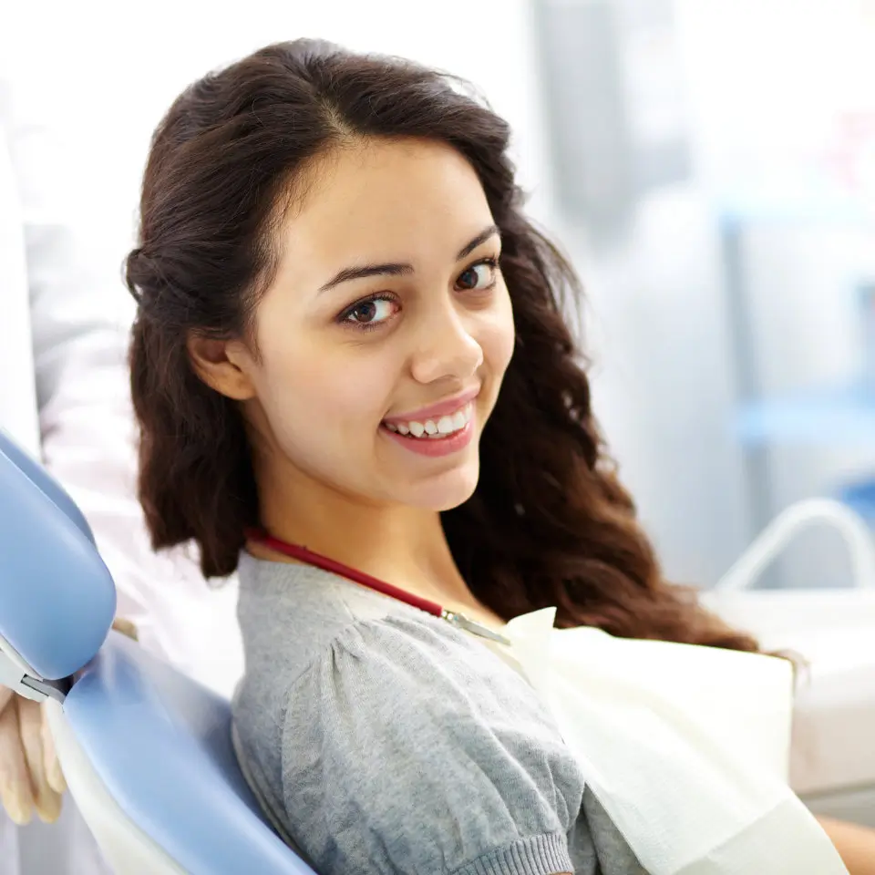 young woman smiling warmly in the dental chair 1