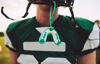 A baseball player with custom athletic mouthguard