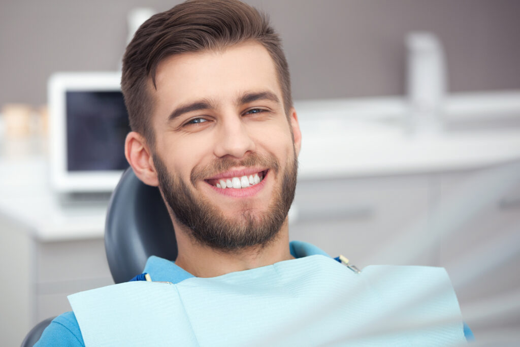 A Complete Guide to Choosing the Right Dentures for Your Smile 7 Patient smiling during dental visit