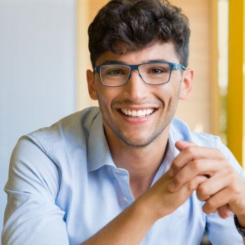 Young man wearing glasses Duluth Dental Studio patient care
