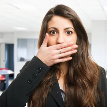 Woman covering her mouth in discomfort
