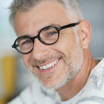 Handsome mature man with glasses Duluth Dental Studio care
