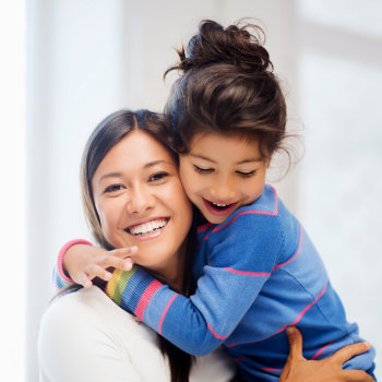 Happy mother hugging daughter Duluth Dental Studio care
