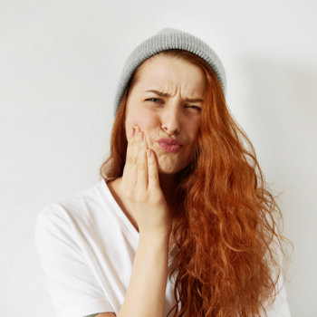 Redhead girl tooth pain Emergency Dental Care in Duluth image