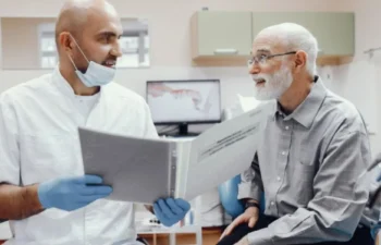 Dentist explaining affordable dental care options to senior man