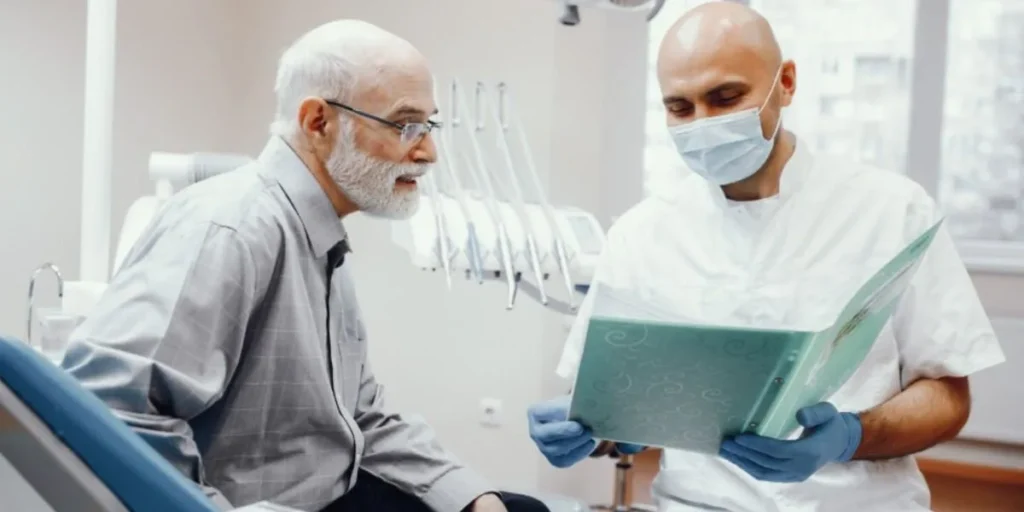 Senior patient discussing dental membership plan with dentist