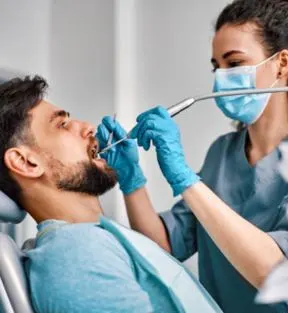 Dentist performing dental implant placement on a patient
